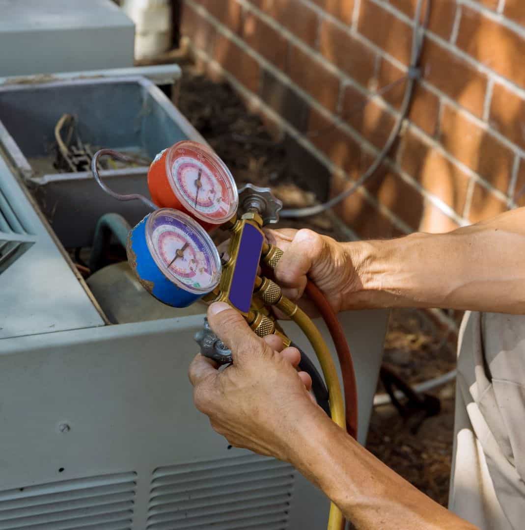 AC repair technician inspecting and servicing an air conditioning unit.
